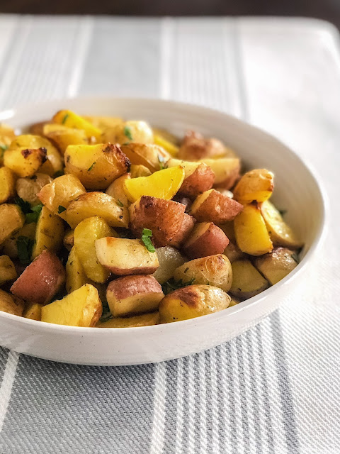 roasted potatoes and parsley in a white bowl