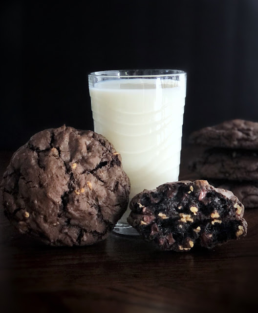 huge double chocolate peanut butter cookies with a tall glass of milk