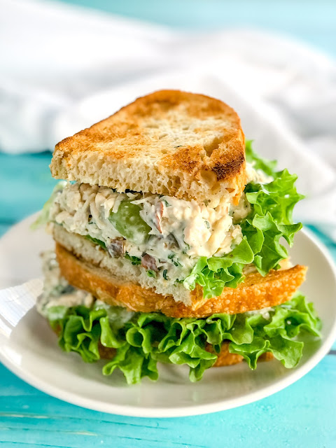 a chicken salad sandwich on a white plate