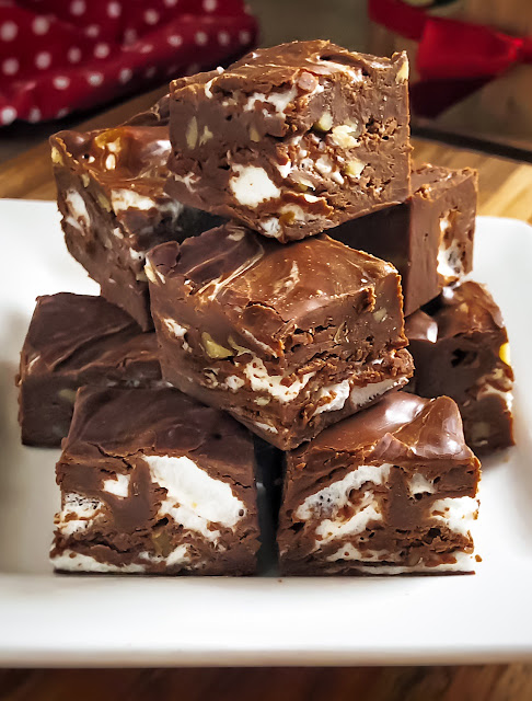 cut up fudge stacked on a white plate