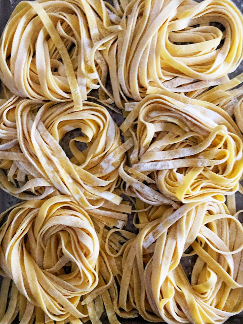 nests of homemade raw fettuccine pasta