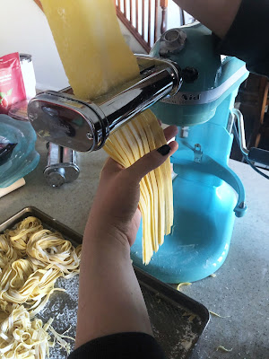 pasta dough being cut in to fettuccine