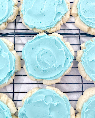 sugar cookies with aqua almond frosting on top