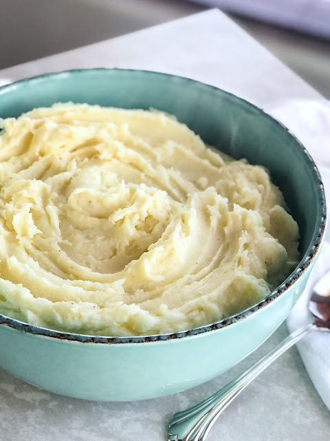 Mashed potatoes in teal bowl