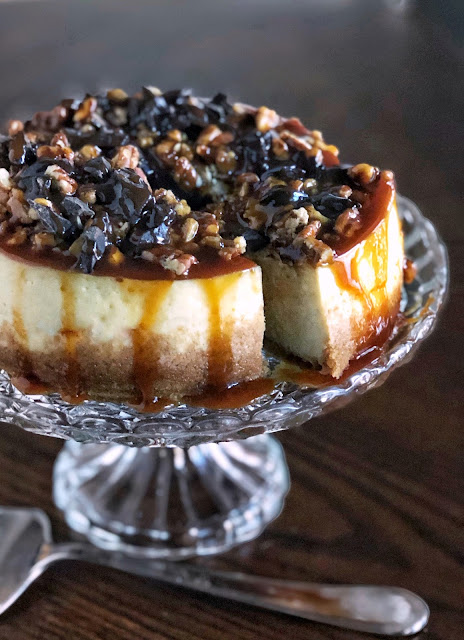 instant pot cheesecake covered in pecans, chocolate and caramel sauce