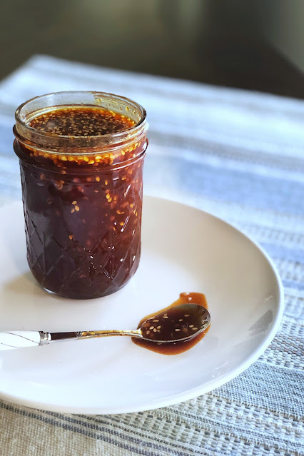spicy sauce in a jar on a white plate
