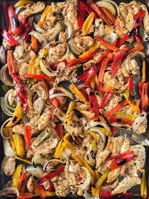 chicken peppers and onions on a baking sheet