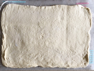 bread dough rolled out in to a rectangle