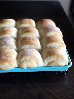 baked rolls on an aqua baking sheet