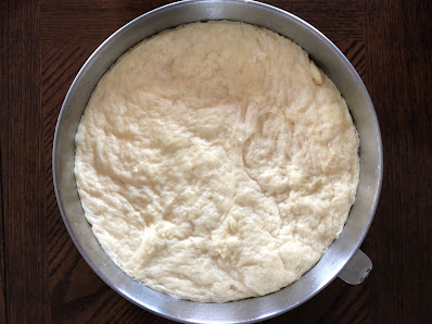 bread dough in a stainless steel bowl