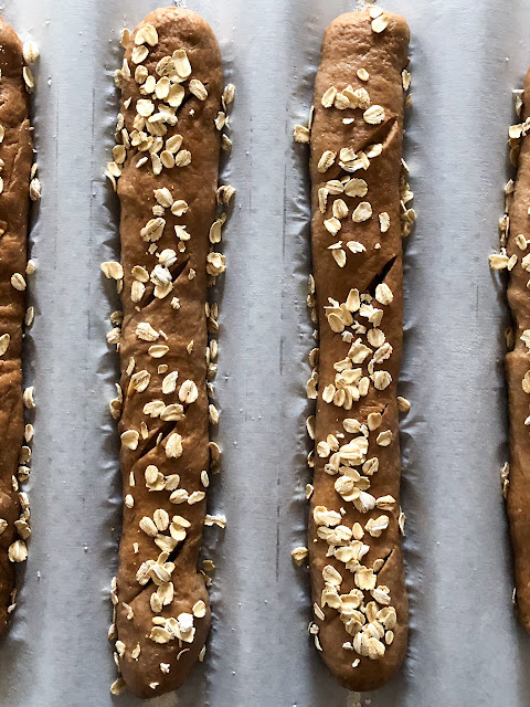 shaped brown bread loaves with oats