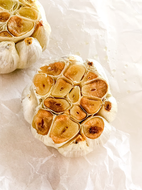 head of roasted garlic on parchment paper