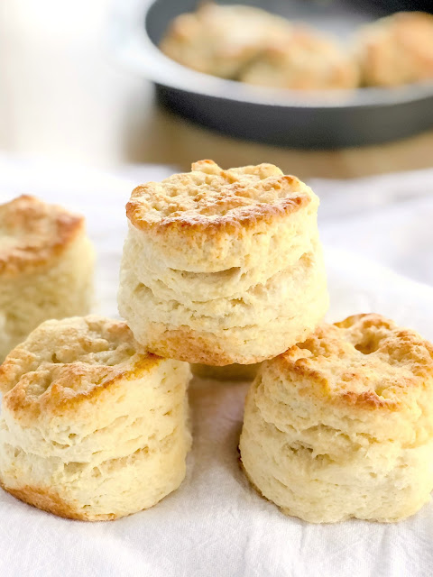 buttermilk biscuits stacked on a white towel