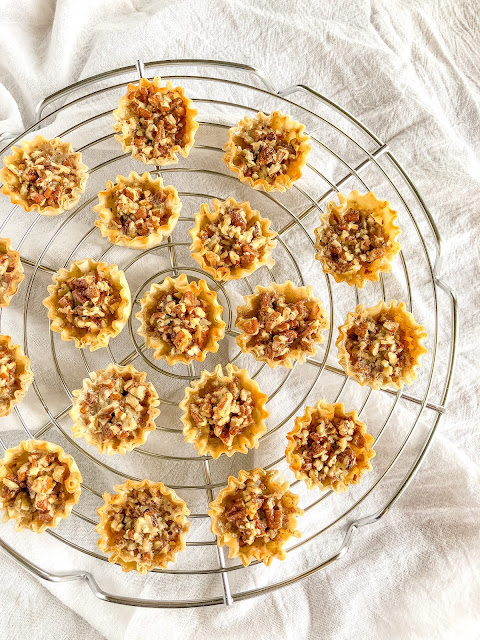 phyllo shells filled with pecans on a cooling rack