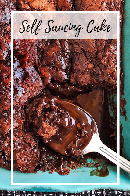 chocolate cake with hot fudge sauce in a teal baking dish
