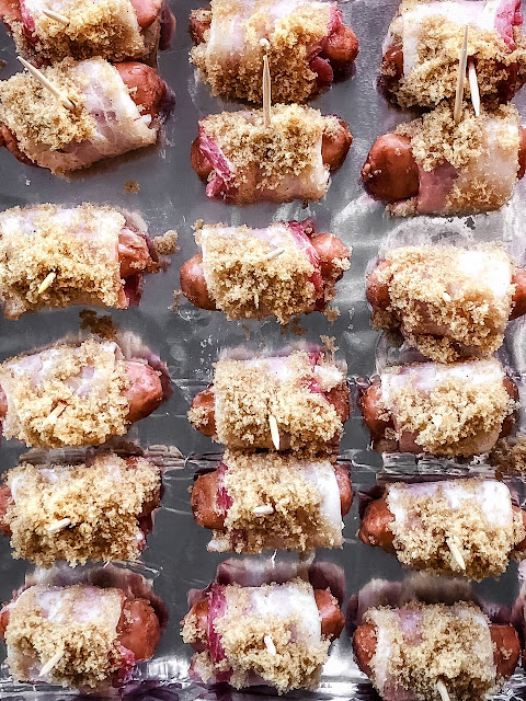 bacon wrapped smokies on foil sprinkled with brown sugar