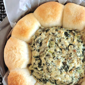 spinach dip in a bread roll ring