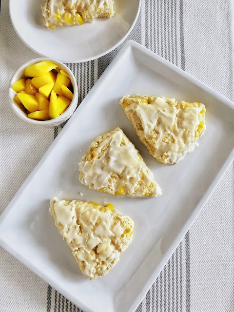 mango almond scones with a small bowl of mango pieces