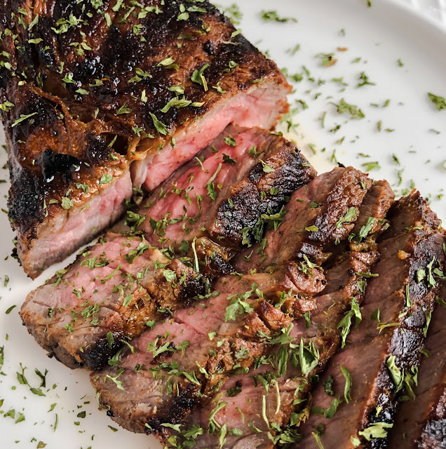 sliced steak with herbs