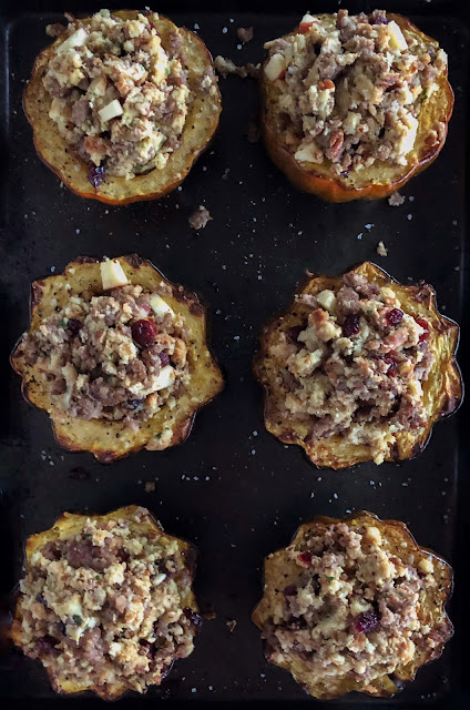 acorn squash with stuffing on a baking tray