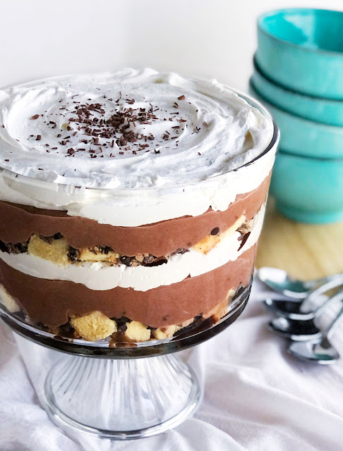 trifle layered with poundcake, chocolate chips, toffee chips, chocolate pudding and whipped cream