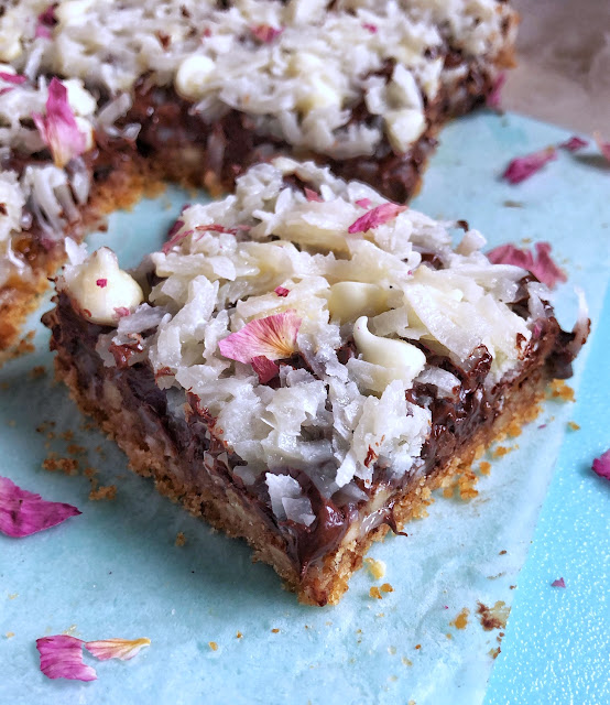 cookie bars with coconut on a blue tray