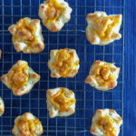 pastry bites filled with cheese on a cooling rack