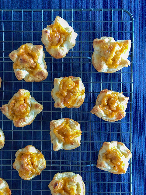 pastry bites filled with cheese on a cooling rack