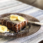 gingerbread cake drizzled with vanilla creme and garnished with sliced bananas