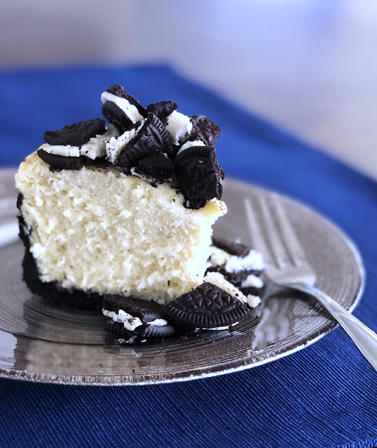 a slice of oreo cheesecake on a grey plate