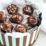 chocolate peanut clusters sprinkled with salt and boxed in white tissue paper