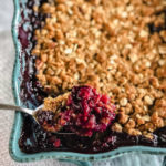 berries with a crunchy topping in a blue dish