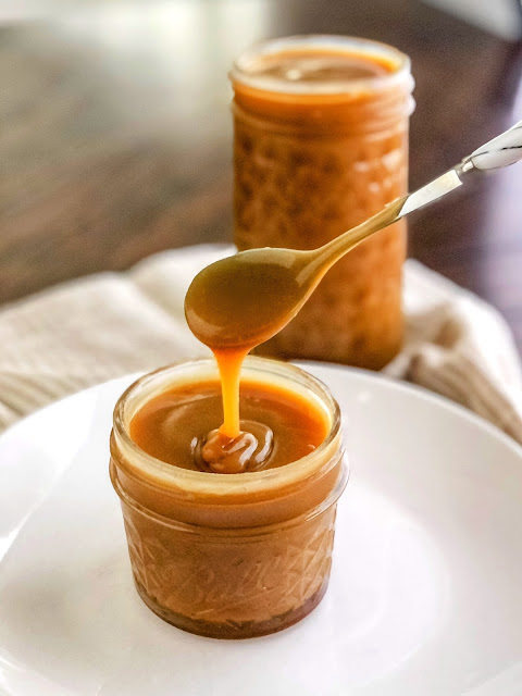 jar of caramel sauce with a spoon