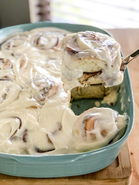 cinnamon rolls with icing in a blue dish
