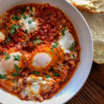 eggs in a thick tomato sauce with ricotta cheese