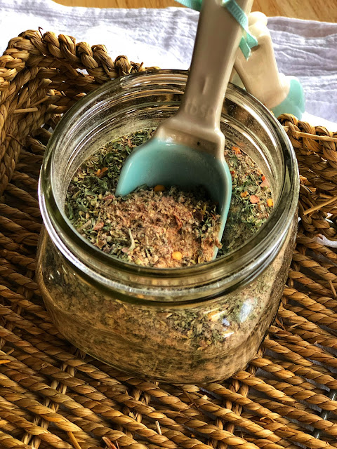 seasoning in a jar with a spoon in it