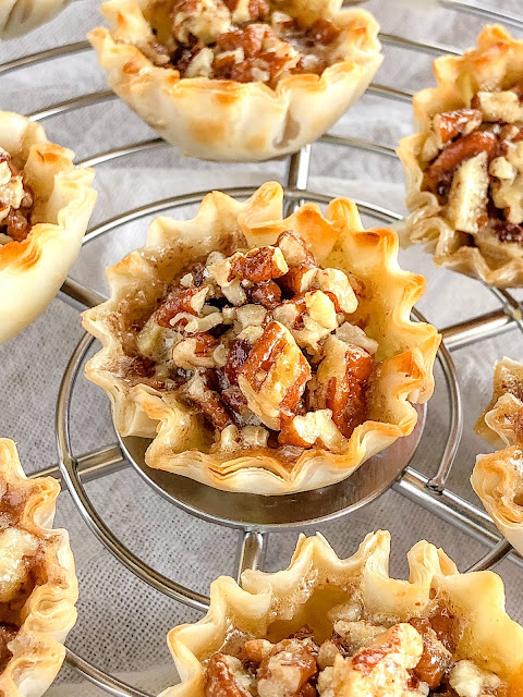 phyllo cups filled with pecans on a cooling rack