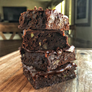 stack of three brownies topped with ganache