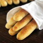 breadsticks wrapped in a white towel