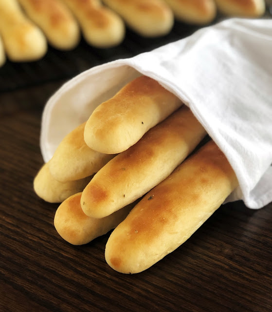 breadsticks wrapped in a white towel