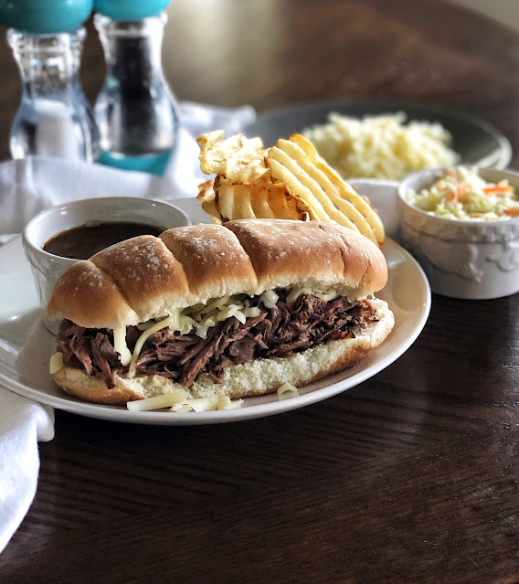 au jus beef french dip sandwich with fries and coleslaw