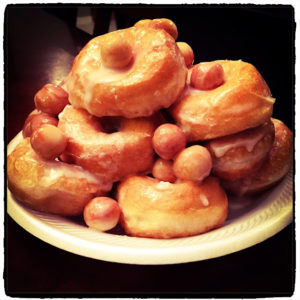 stack of donuts and holes on a paper plate