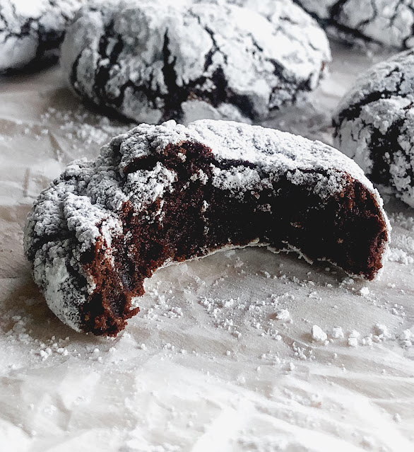 chocolate cookies covered in powdered sugar