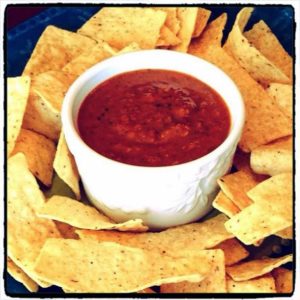 salsa in a white bowl with tortilla chips