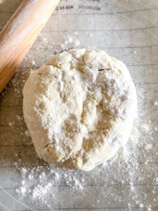 dough formed in to a circle with a rolling pin