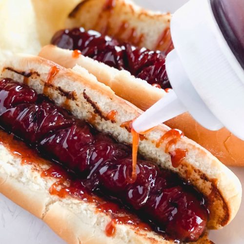 hot dogs on buns with sauce