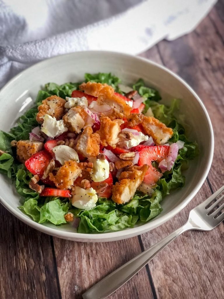 salad with strawberries, chicken strips and goat cheese