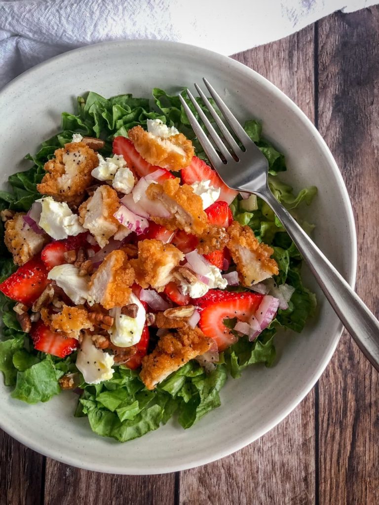 salad with strawberries, chicken strips and goat cheese