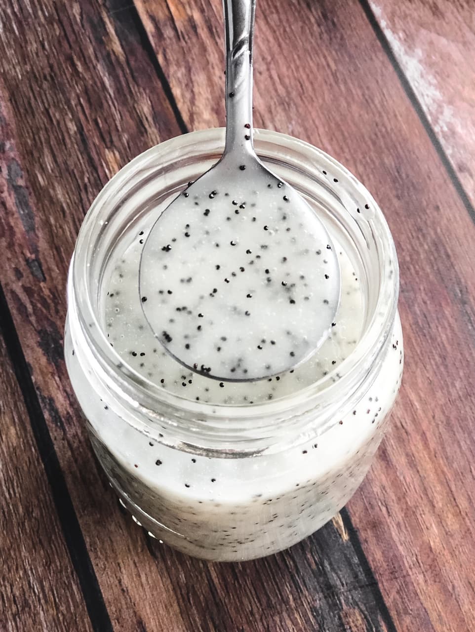 spoonful of dressing over a jar