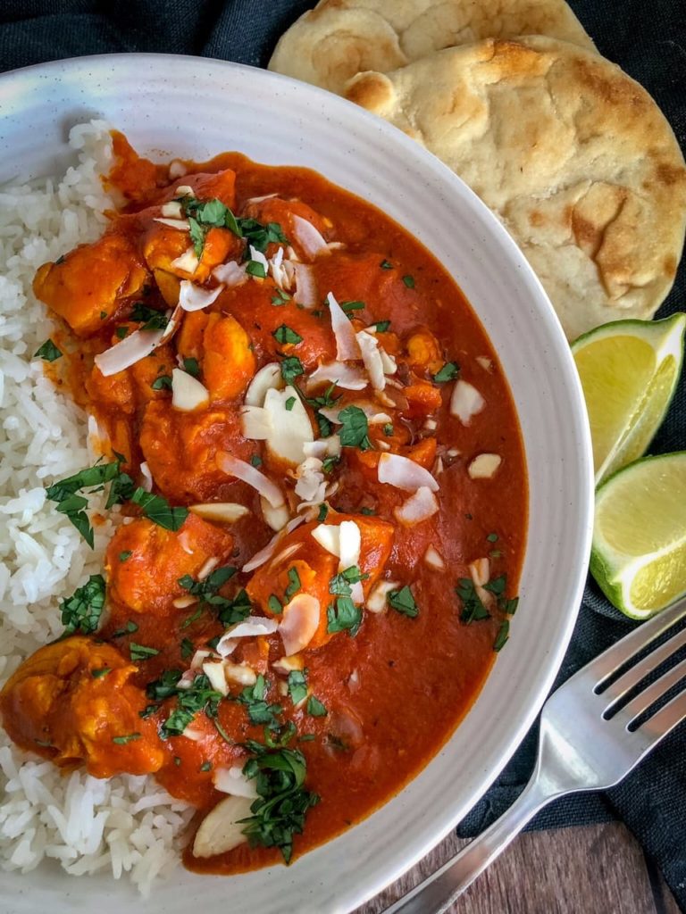 chicken curry with rice naan and limes